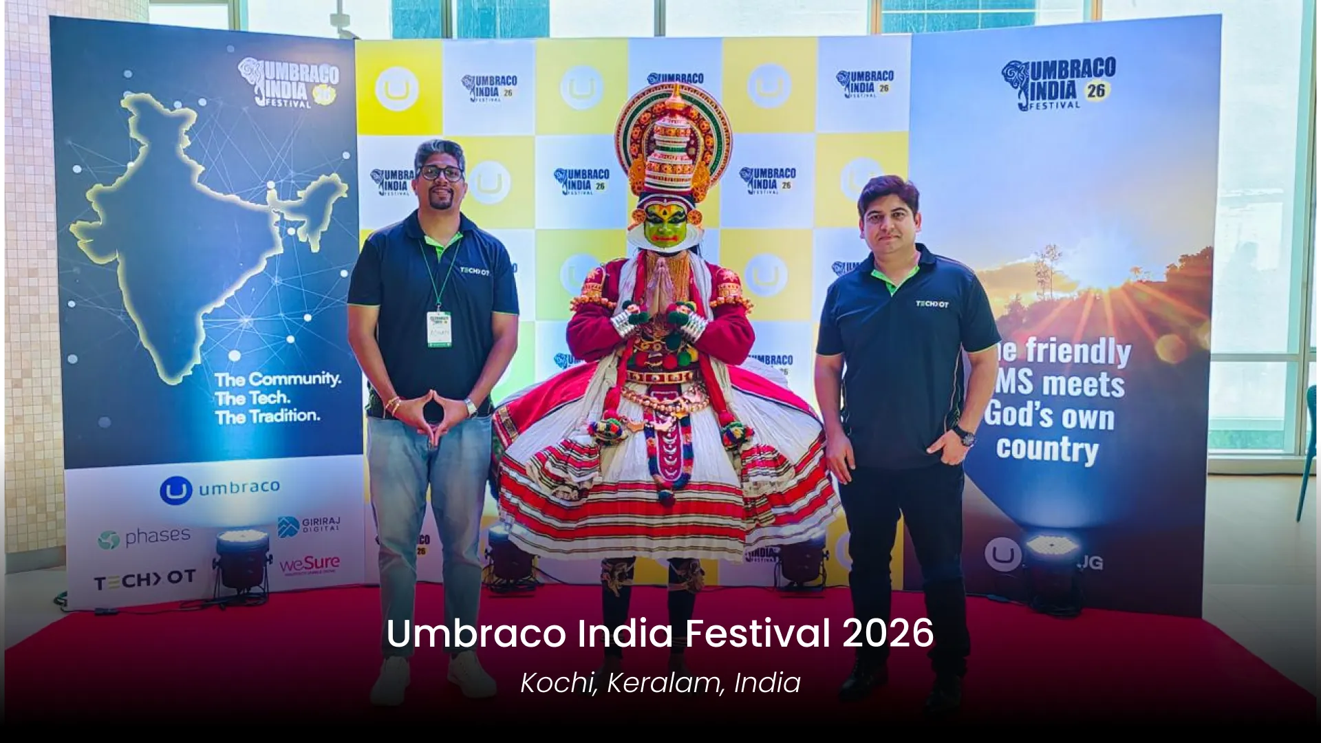 Techxot team members Mateen And Rahul with a Kathakali performer at Umbraco India Festival 2026 in Kochi